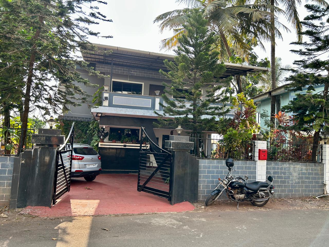Exterior of Shivaaz Hill Top Villa surrounded by greenery
