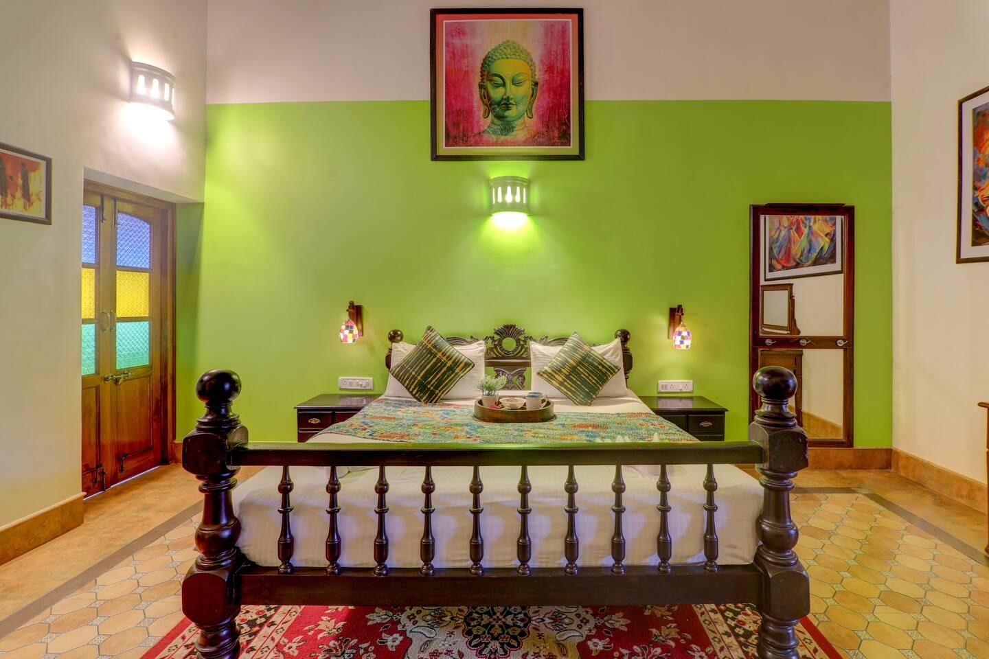 Bedroom with green feature wall at House of Legends Villa, Saligao