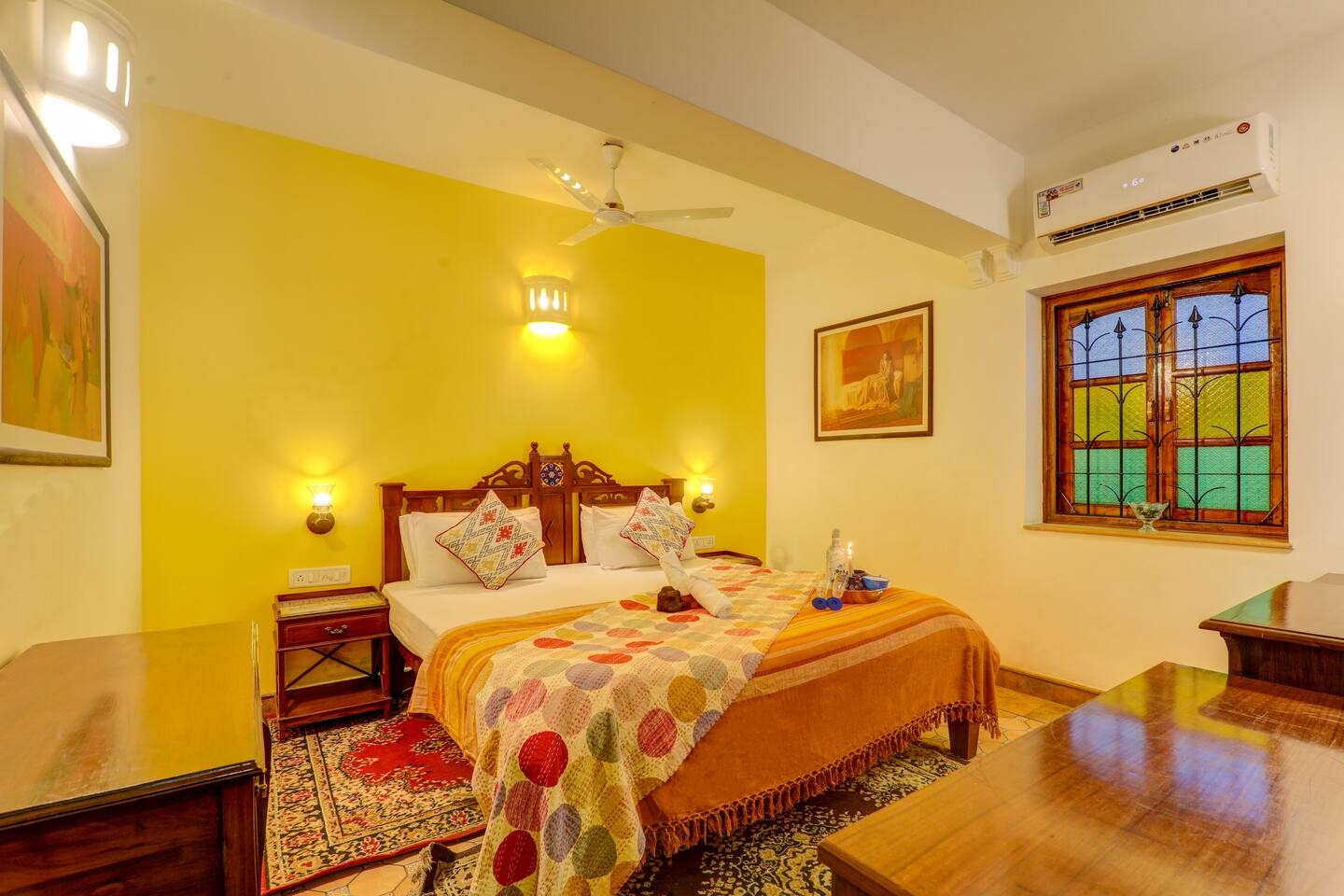 Bedroom with yellow feature wall at House of Legends Villa, Saligao