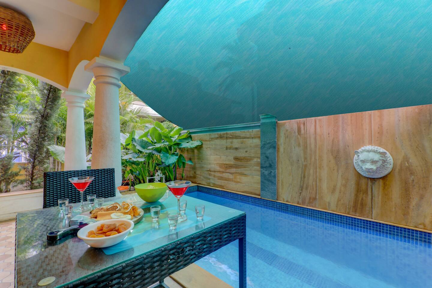 Poolside dining area at House of Legends Villa, Saligao